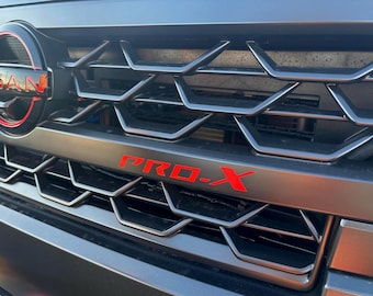Grille-embleemaccent door LUDesignsNY op maat gemaakt en ontworpen voor een Nissan Frontier Pro-X en Pro-4X uit 2025-26 met GRATIS LEVENSLANGE VERVANGING