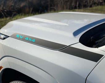 May include: White truck hood with a black and gray stripe and the text "SV 4X4" in turquoise.