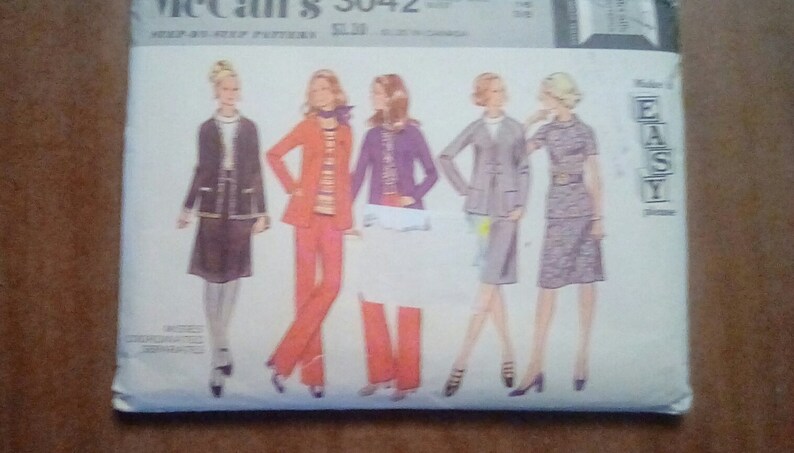 May include: A vintage sewing pattern for five different outfits. The pattern is for McCall's 3042 and is labeled "Easy" on the front. The outfits include a skirt and jacket, pants and jacket, a dress, and two other outfits.