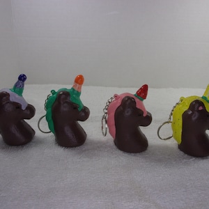 Four fruit and chocolate themed squishy unicorn keychain set