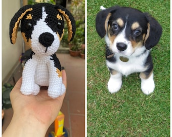May include: A crocheted stuffed dog toy with black, white and brown fur. The toy is sitting on a person's hand.