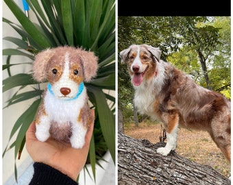 May include: A crocheted stuffed dog toy with brown and white fur, wearing a blue collar. Next to it is a real Australian Shepherd dog with brown, white, and black fur, standing on a tree trunk.