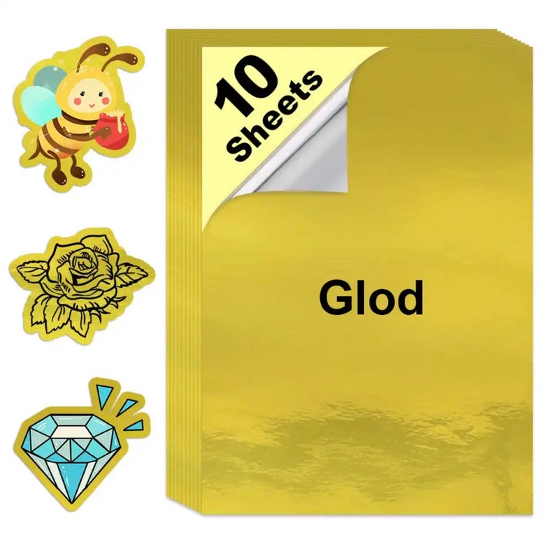 May include: A stack of ten gold-colored sheets with the word "Glod" printed on the front. The corner of the top sheet is peeled back. Three stickers are to the left: a bee, a rose, and a diamond.