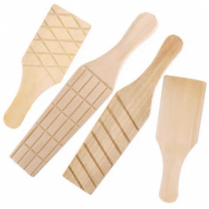 May include: Four wooden butter paddles with textured surfaces. Two paddles have grid patterns, one has a diagonal pattern, and one is smooth. All have long, narrow handles and are made of light-colored wood.