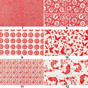May include: A collection of red and white patterned fabric swatches. Designs include small floral patterns, stylized flowers, butterflies, and koi fish. The koi fish design includes a measurement of 10.3cm.