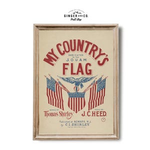 May include: A framed vintage print of "My Country's Flag." The artwork uses red, white, and blue colours and patriotic imagery. The text includes "Dedicated to the J.O.U.A.M." and the names Thomas Shirley and J.C. Heed.