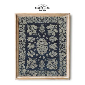 May include: A framed print of a vintage floral design in white on a dark blue background. The design features a repeating pattern of flowers, leaves, and birds. The frame is a light wood colour.
