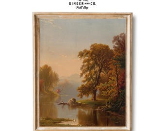 May include: Framed vintage art print featuring a serene landscape with a river, trees, and a boat. The artwork showcases warm autumn colors, with a light blue sky and a gold-toned frame. The print includes the text "GINGER AND CO. Print Shop."