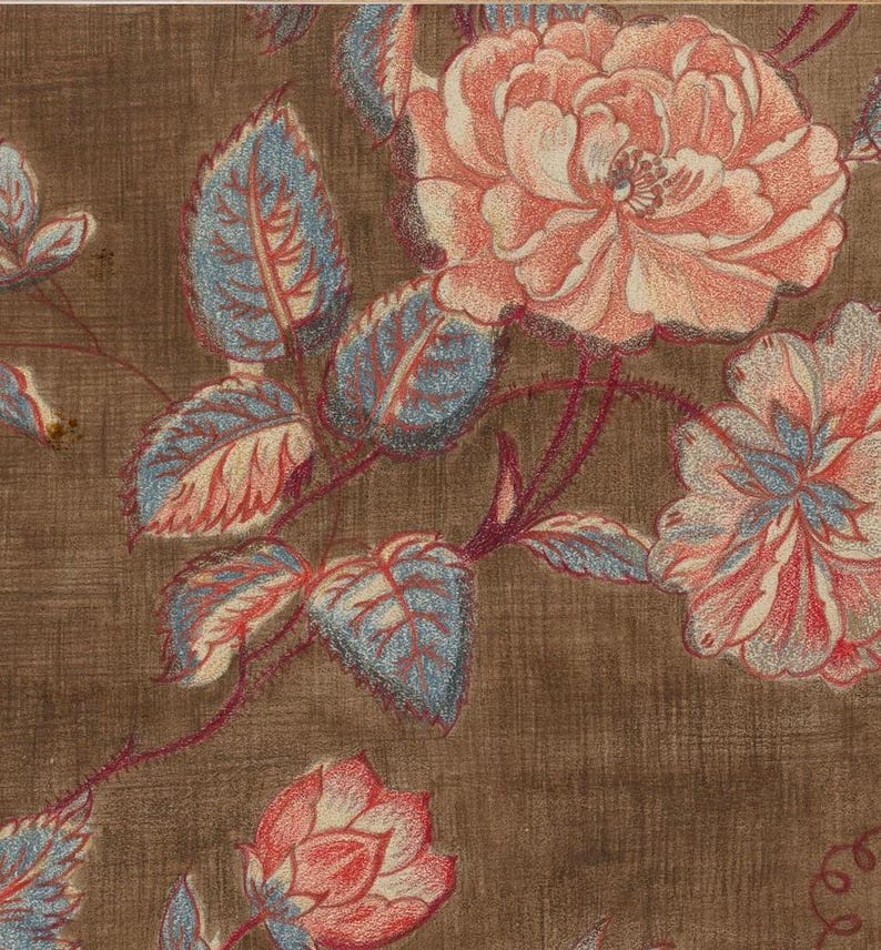May include: A brown fabric with a floral pattern. The flowers are pink and white with blue and red leaves.