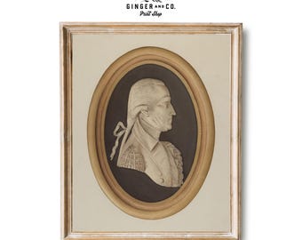 May include: A framed print of a black and white portrait of a man in profile. The portrait is in an oval frame with a gold-colored border. The frame is on a white background.