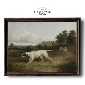 May include: A vintage painting depicting a hunting scene with a white dog running through a field, two other dogs in the background, and a hunter in the distance. The painting is framed in a dark wood frame.