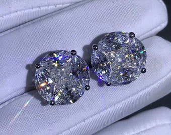 May include: A pair of silver earrings with large, clear, round, faceted stones. The stones have a square shape in the center.
