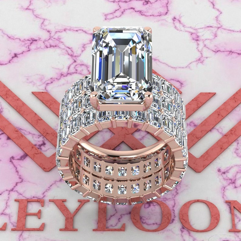 May include: A rose gold engagement ring with a large emerald cut center stone and a band of smaller baguette and square cut diamonds.