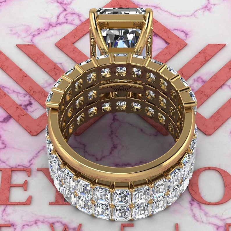 May include: A gold ring with a large, square-cut diamond center stone and a band of smaller diamonds. The band is made up of three rows of diamonds, each row set in a different pattern.