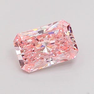 May include: A rectangular-cut, light pink diamond with multiple facets. The gemstone is set against a white background, showcasing its clarity and brilliance. The diamond's shape is a modified brilliant cut, reflecting light from all angles.