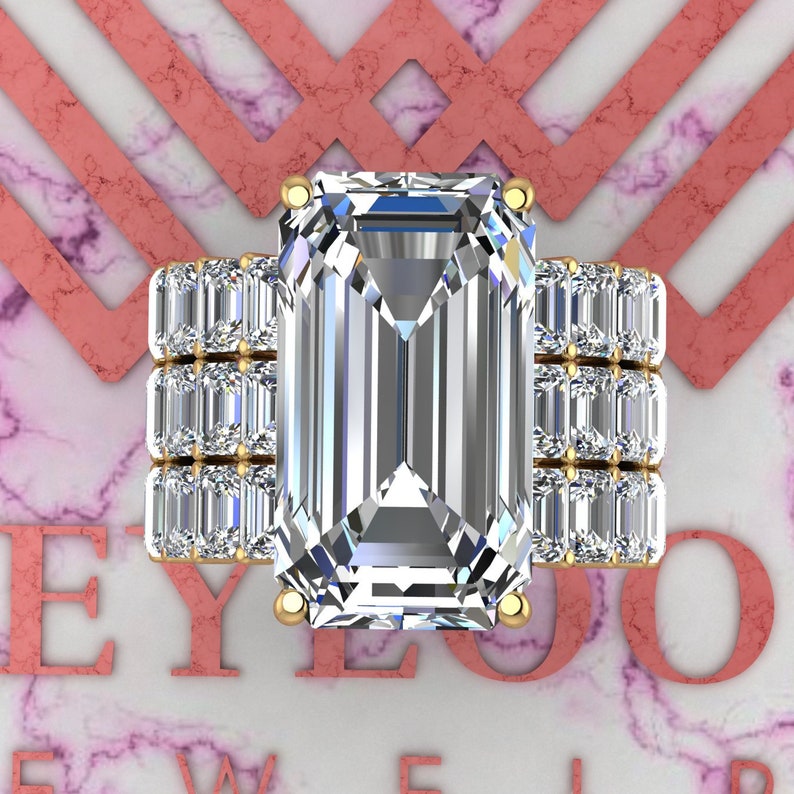 May include: A gold ring with a large emerald-cut diamond center stone and a band of smaller diamonds.
