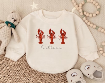 May include: A cream-colored long-sleeved shirt with a graphic of three red lobsters and the name "William" printed below.