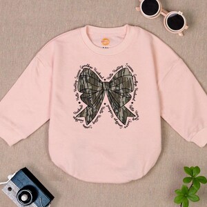 May include: Pink sweatshirt with a camouflage bow and the words "Hello Hunting Season Goodbye Husband" repeated around the bow.