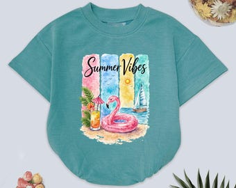 May include: Teal short-sleeved baby bodysuit with a colorful summer graphic. The graphic includes a pink flamingo float, a cocktail, a sailboat, and the words "Summer Vibes".
