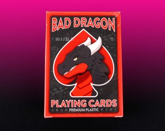 May include: A deck of playing cards with a black dragon illustration on the front. The box is red with black text that reads "Bad Dragon Playing Cards" and "Premium Plastic".