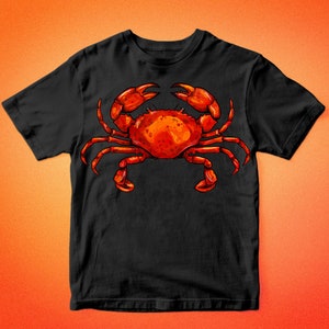 May include: Black t-shirt with a red crab illustration. The crab has large claws and is facing forward. The text "BARKALO DESIGN" is at the top and bottom of the image.