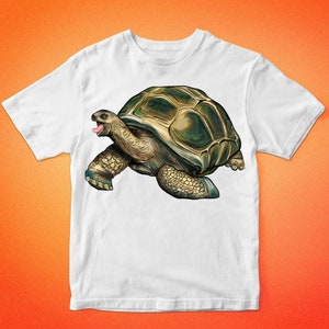 May include: White t-shirt with a cartoon illustration of a green and brown tortoise with its tongue sticking out.