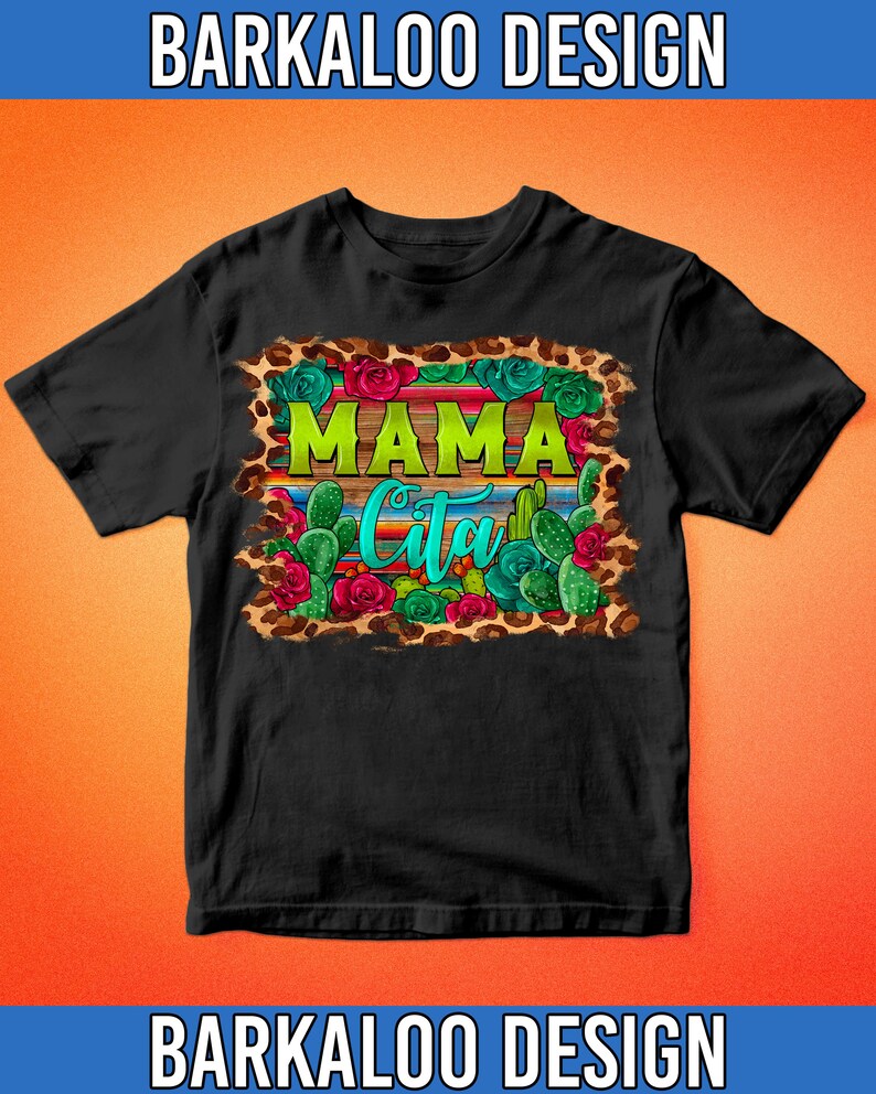 May include: Black t-shirt with a colorful graphic design. The design features the word "MAMA" in green, the word "Cita" in turquoise, and images of cacti, roses, and a leopard print border. The text "BARKALOO DESIGN" is at the top and bottom.