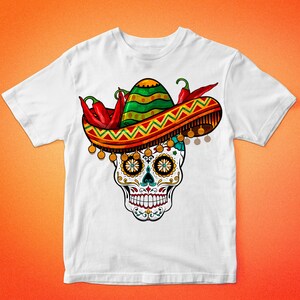 May include: White t-shirt with a colorful sugar skull wearing a sombrero with red chili peppers. The skull has intricate details and is surrounded by a yellow and orange patterned border.