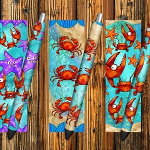 May include: Five colorful pens with a beach theme. Each pen features a different design with crabs, starfish, and seashells. The pens are perfect for adding a touch of fun to your writing.