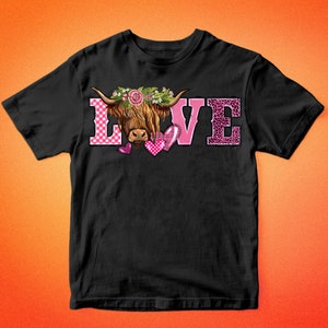 May include: Black t-shirt with the word "LOVE" in pink, featuring a Highland cow graphic. The "L" is checkered, the "O" has a cow, and the "E" has a leopard print. The shirt has the text "BARKALOO DESIGN" at the top and bottom.