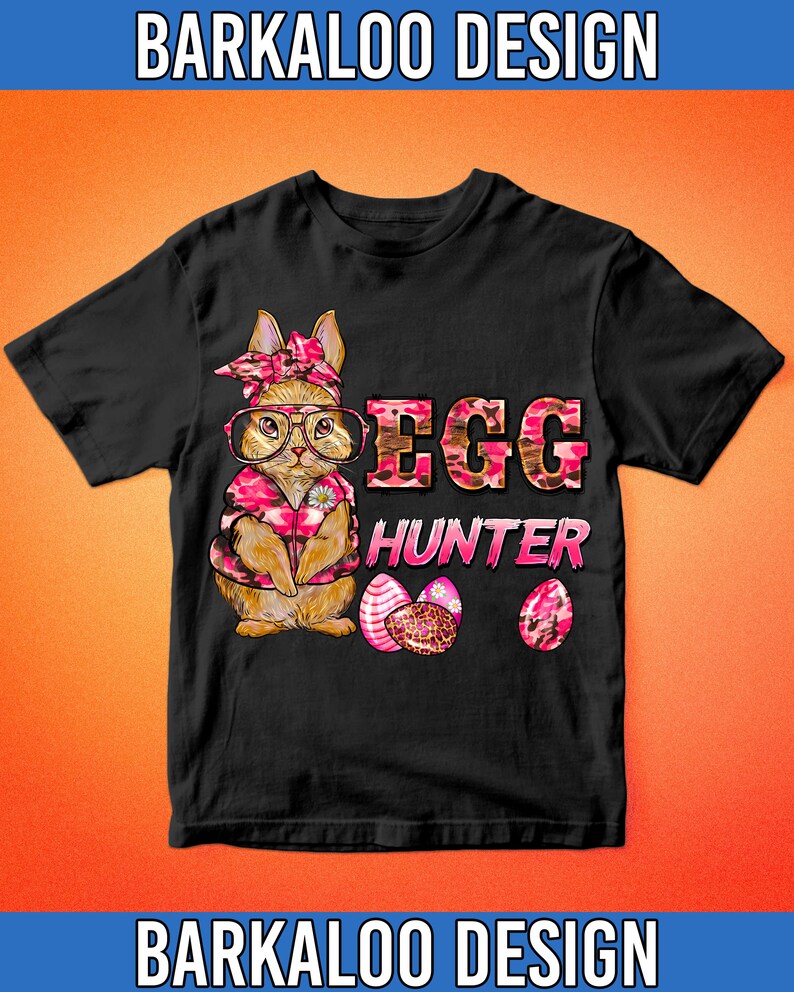 May include: Black t-shirt featuring a cartoon bunny wearing glasses and a pink floral patterned outfit. The text "EGG HUNTER" is in pink and brown camouflage print. Three decorated Easter eggs are also shown.