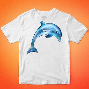 May include: White t-shirt with a blue dolphin jumping out of the water. The dolphin is detailed with blue and white water patterns.