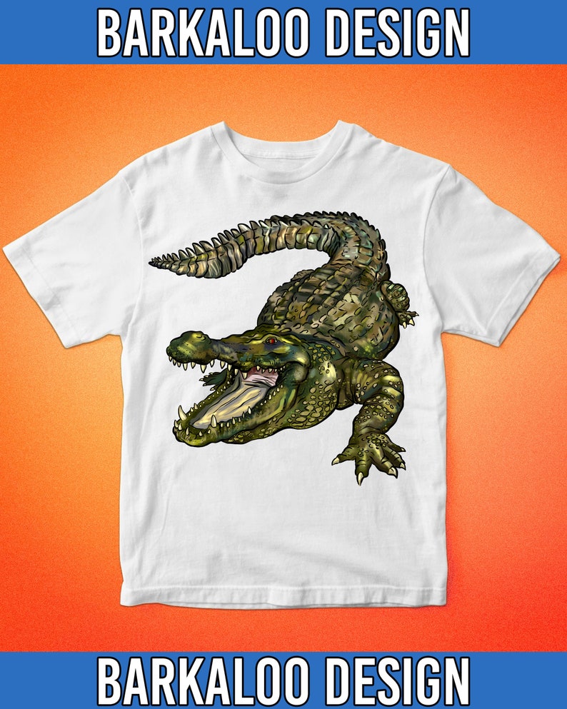 May include: White t-shirt with a green and brown alligator graphic. The alligator has its mouth open and is facing the right side of the image. The t-shirt has the text "BARKALO DESIGN" at the top and bottom of the image.