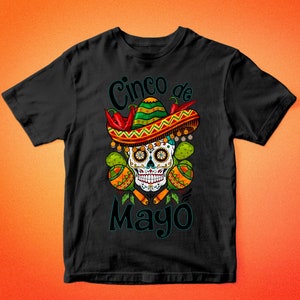 May include: Black t-shirt with a colorful graphic of a sugar skull wearing a sombrero and holding maracas. The text "Cinco de Mayo" is written below the skull.