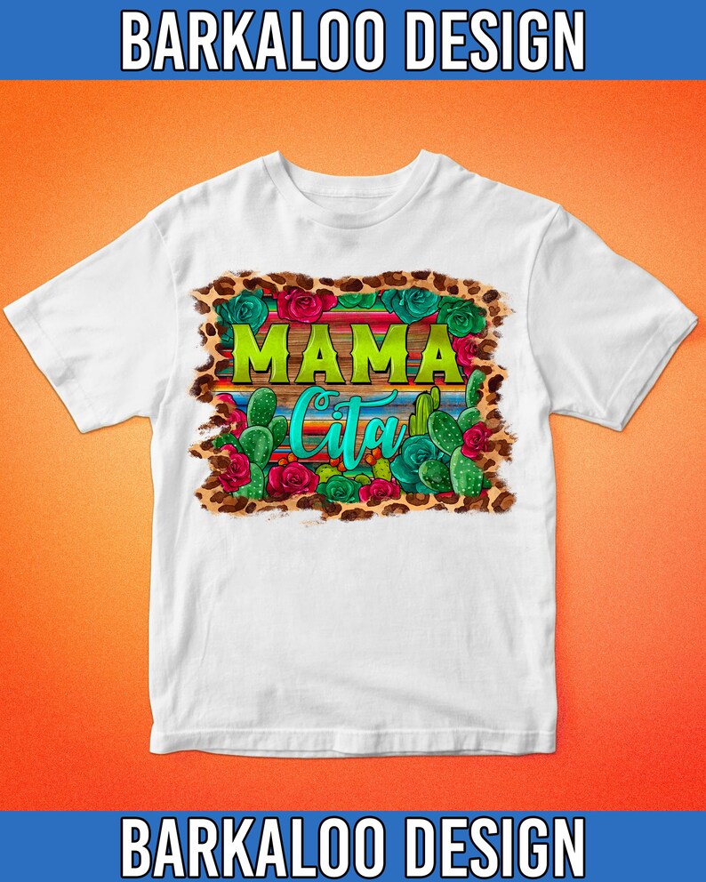 May include: White t-shirt with a colorful graphic design. The design features the words "MAMA Cita" in green and turquoise, surrounded by cacti, roses, and a leopard print border. The text "BARKALOO DESIGN" is at the top and bottom.