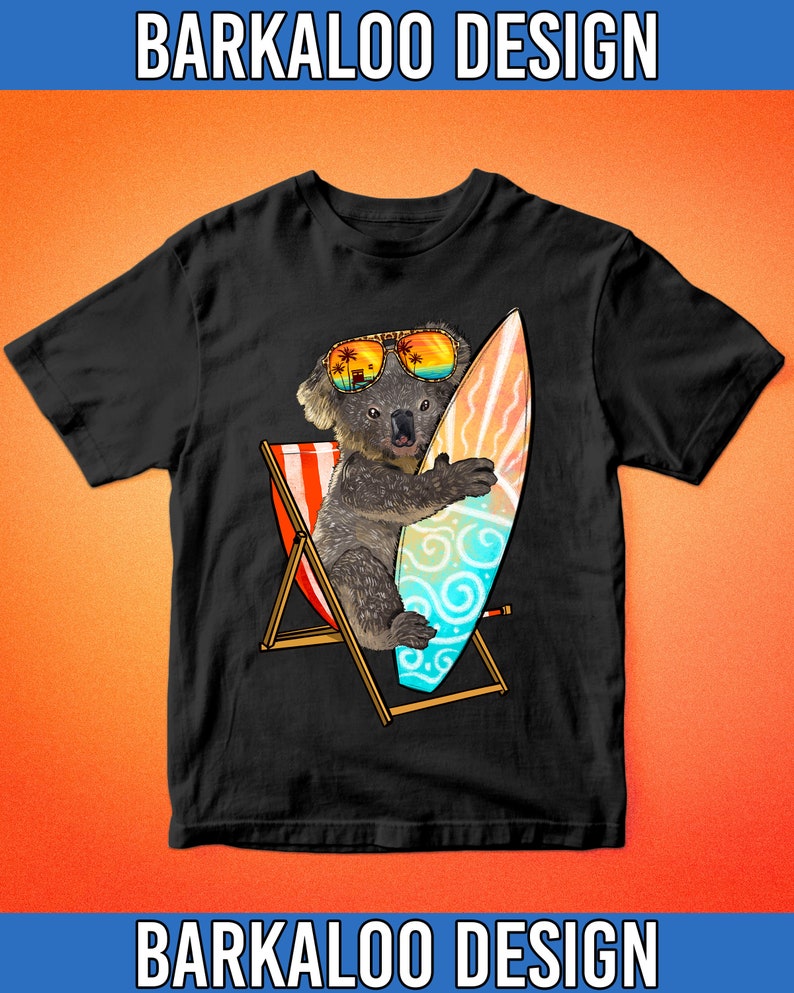 May include: Black t-shirt featuring a cartoon koala wearing sunglasses and holding a surfboard. The koala is sitting in a beach chair with a red, white, and blue striped design. The surfboard has a blue, green, and white design with swirls.