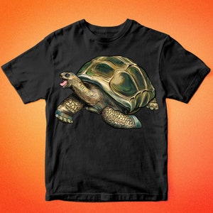 May include: Black t-shirt with a graphic of a green and brown tortoise with its mouth open. The tortoise is walking to the right. The text "BARKALO DESIGN" is at the top and bottom of the image.