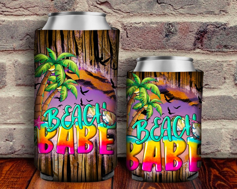 May include: Two colorful can coolers with a wood grain background. The design features palm trees, birds, and the text "Beach Babe".