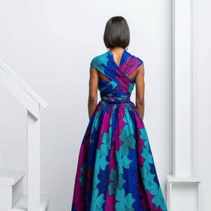 May include: A long, flowing dress with a blue, teal, and pink floral print. The dress has a wrap-style bodice and a full skirt.