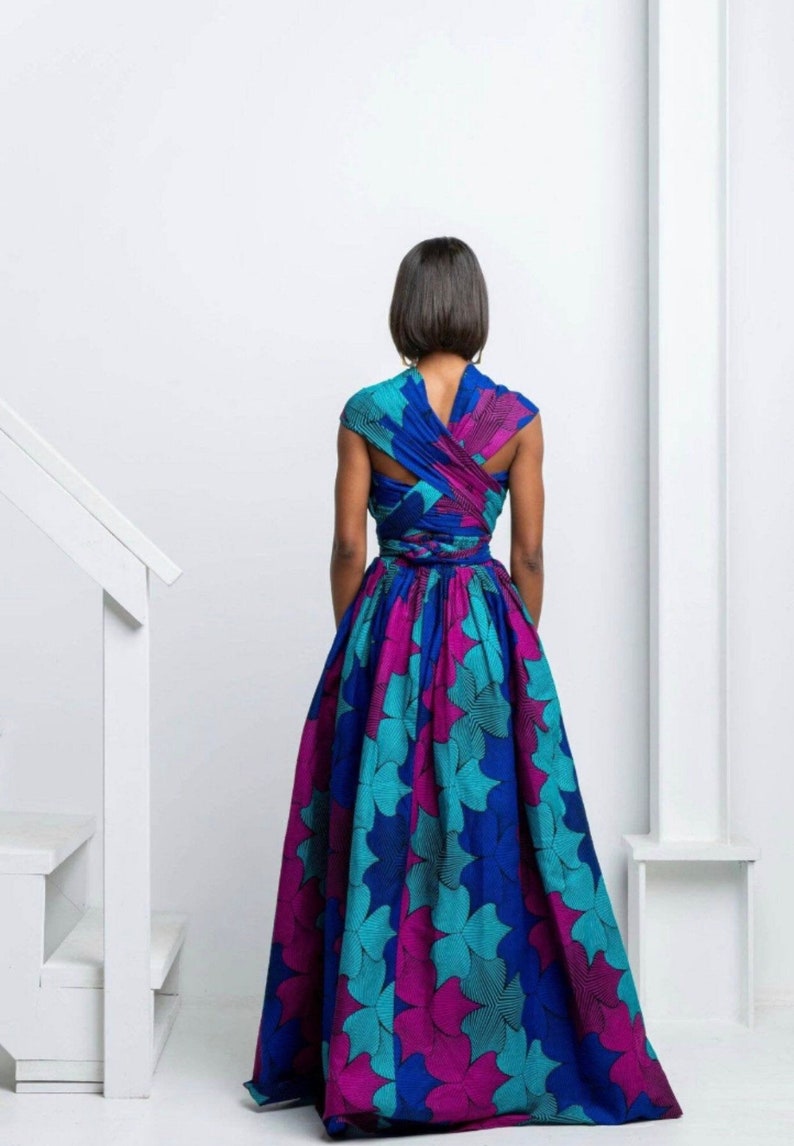 May include: A long, flowing dress with a blue, teal, and pink floral print. The dress has a wrap-style bodice and a full skirt.