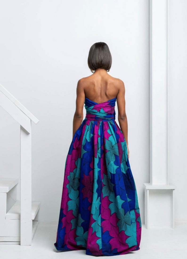 May include: A strapless maxi dress with a blue, teal, and pink floral print. The dress has a fitted bodice and a flowing skirt.