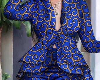 May include: A blue and gold patterned pantsuit with a ruffled hem and a deep V-neckline.