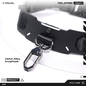May include: Close-up of a black collar with a metal alloy snap hook. The collar has a textured nylon handle and white accents. The text "RELEASE 2024" is visible. The words "Metal Alloy Snaphook" are also visible.