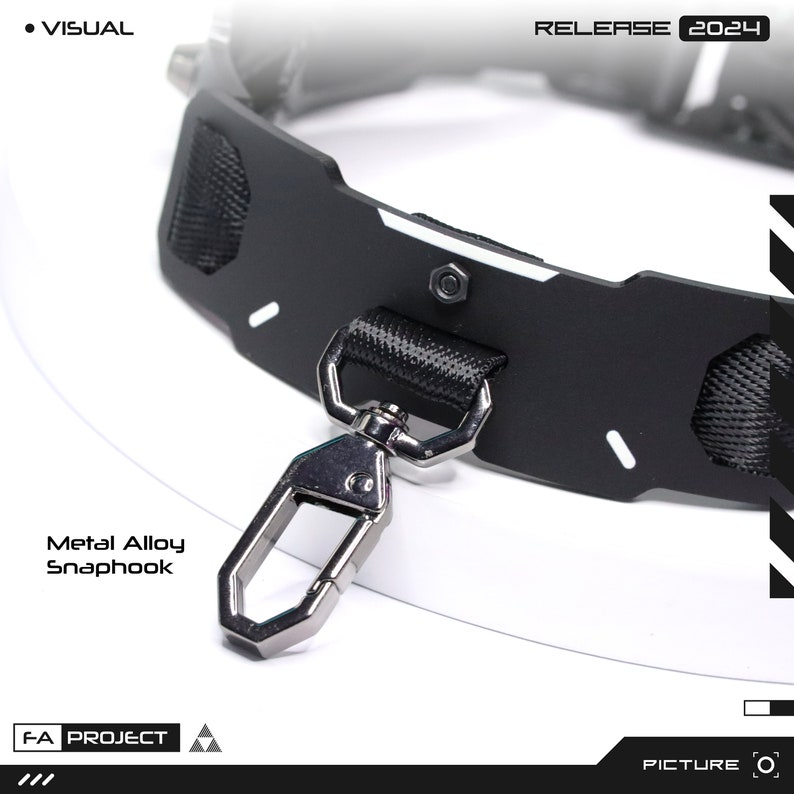 May include: Close-up of a black collar with a metal alloy snap hook. The collar has a textured nylon handle and white accents. The text "RELEASE 2024" is visible. The words "Metal Alloy Snaphook" are also visible.