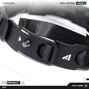 May include: Close-up of a black collar with a woven nylon strap and metal accents. The collar features the text "20MM" and the logo of a triangle. The words "RELEASE 2024" are also visible.