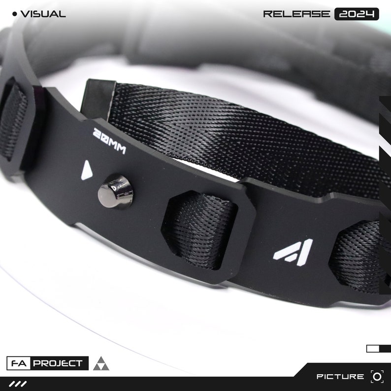 May include: Close-up of a black collar with a woven nylon strap and metal accents. The collar features the text "20MM" and the logo of a triangle. The words "RELEASE 2024" are also visible.