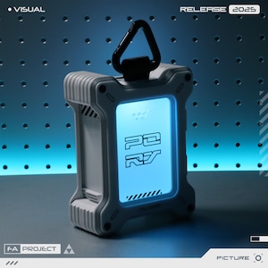 May include: A white and grey futuristic device with a glowing blue screen, displaying stylized text. It features a black handle and a robust design. The text "RELEASE 2025" is visible. The device is part of the "F-A PROJECT".