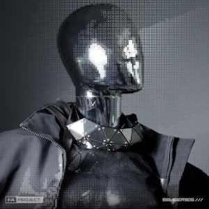 May include: A chrome-finished mannequin head and neck wearing a geometric, silver-toned metal collar made of triangular plates joined by rivets. The mannequin wears a dark gray, high-collared jacket. Text reads FA PROJECT and SS-SERIES ///.