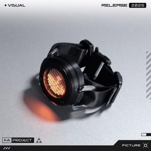 May include: A black circular digital watch with a glowing orange dot-matrix display featuring a bird-like icon. The watch has a thick black nylon strap with a metallic buckle mechanism. Text on the image includes VISUAL, RELEASE 2026, FA PROJECT, and PICTURE.