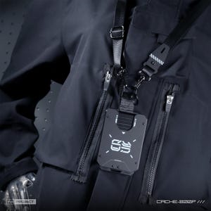 May include: A black tactical jacket featuring multiple zippered pockets and a black neck strap holding a rectangular black card holder. The card holder displays a white graphic logo with the text "09" and is attached via a black nylon strap.